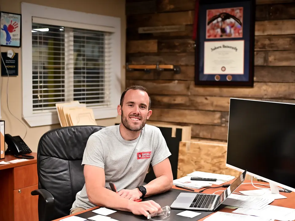 Josh McGill, president of Shoals Box & Pallet, at his desk in the Florence office